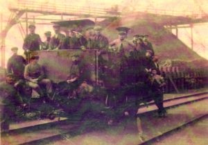 Miners In And Around A Hopper