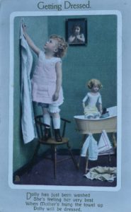 Postcard Infant Girl Dressing Dolly